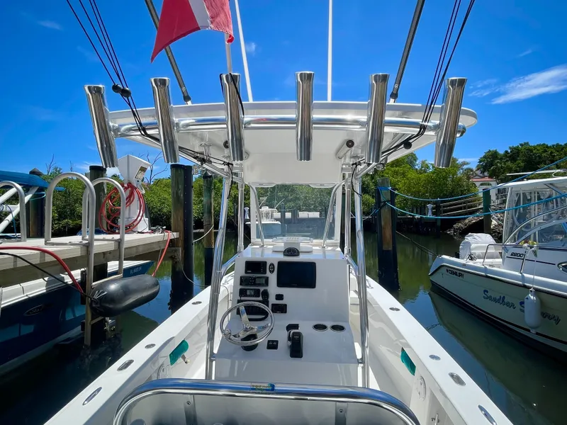 Slide: The Image of 2019 Rambo 27 boat docked at marina under clear blue sky. - 9