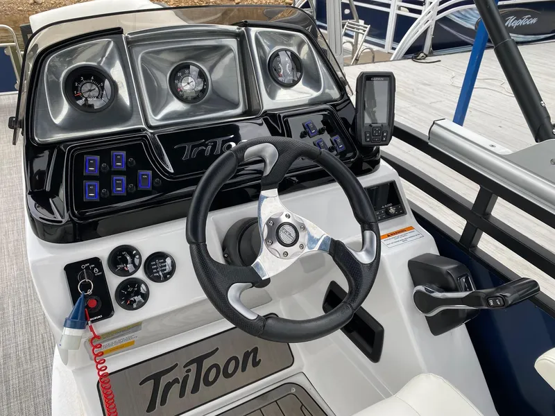 Slide: The Image of Control console of 2023 JC NEPTOON SPORT 21TT boat with steering wheel and gauges. - 12