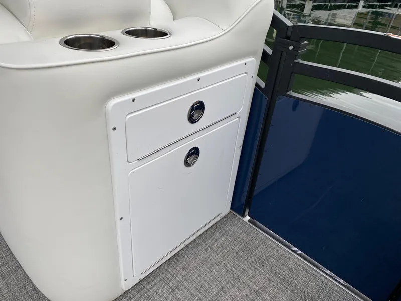 Slide: The Image of 2023 JC NEPTOON SPORT 21TT boat interior with storage compartments and cup holders. - 8