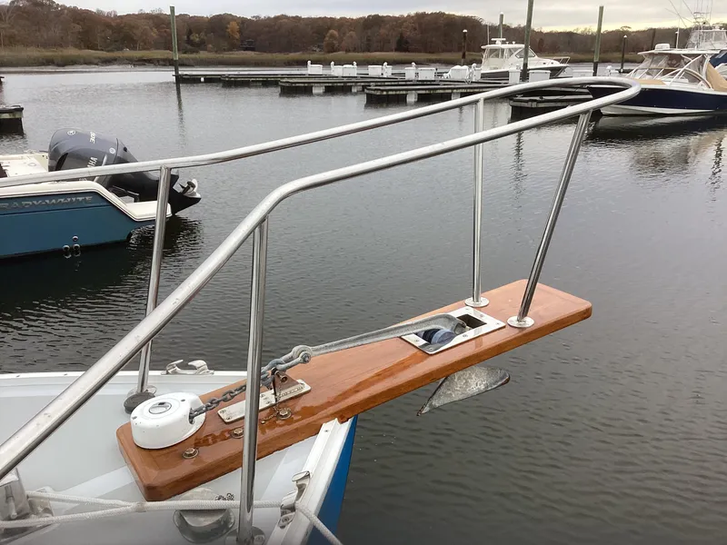 Slide: The Image of Bow of a 1993 Ellis Downeast Hardtop boat docked in a marina. - 10
