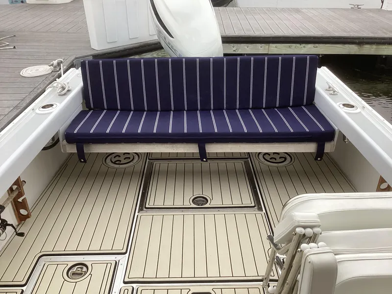 Slide: The Image of 1993 Ellis Downeast Hardtop boat with striped seating and clean deck. - 12