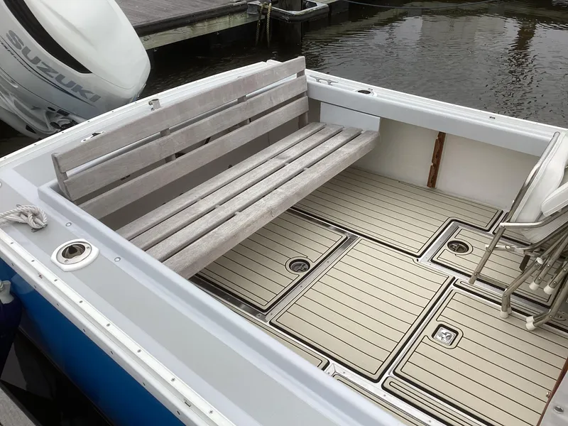 Slide: The Image of 1993 Ellis Downeast Hardtop boat with wooden bench and Suzuki outboard motor. - 14