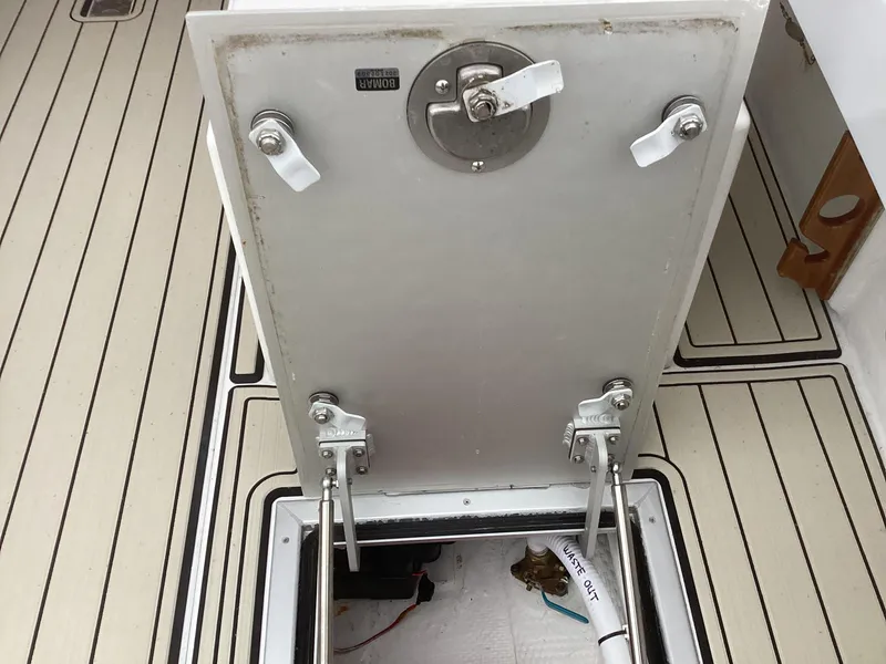 Slide: The Image of 1993 Ellis Downeast Hardtop boat hatch open, revealing storage compartment. - 16