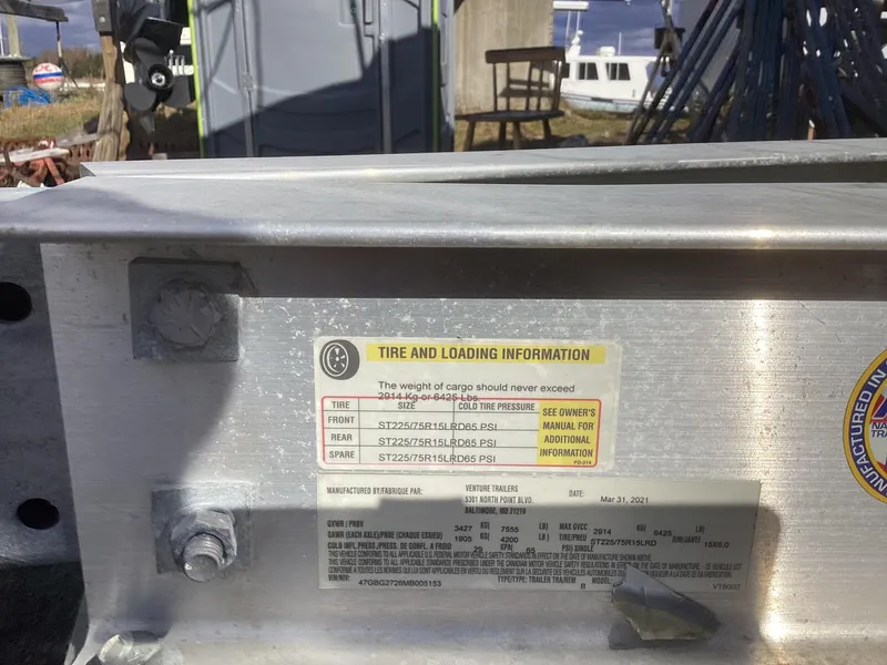 Slide: The Image of Tire and loading information label on a 1993 Ellis Downeast Hardtop boat. - 17