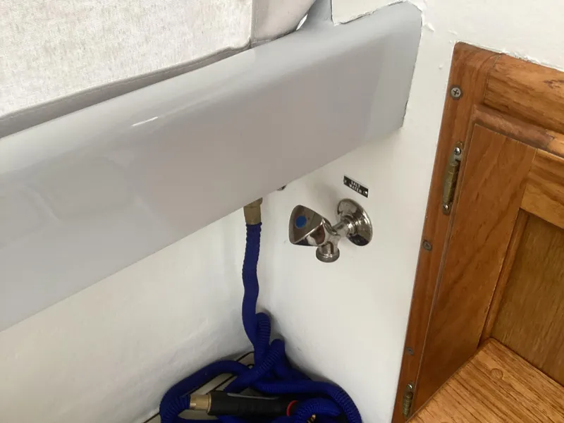 Slide: The Image of Close-up of 1993 Ellis Downeast Hardtop boat interior with blue rope and wooden panel. - 26