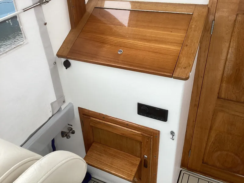 Slide: The Image of Interior of 1993 Ellis Downeast Hardtop boat with wooden cabinetry and seating. - 28