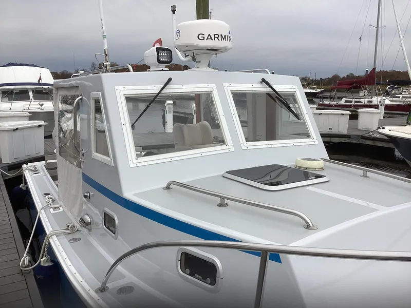 Slide: The Image of 1993 Ellis Downeast Hardtop boat docked, featuring Garmin navigation equipment. - 5