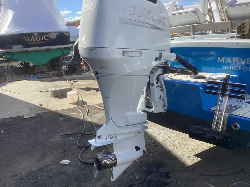 Slide: The Image of 1993 Ellis Downeast Hardtop with Suzuki outboard motor in a boatyard. - 8