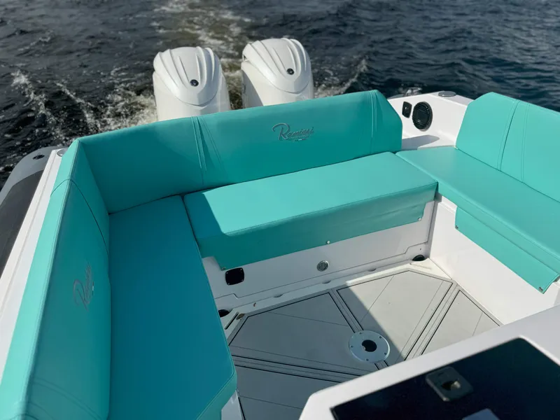 Slide: The Image of 2025 Ranieri CAYMAN 27.0 SPORT TOURING boat with turquoise seating on water. - 28