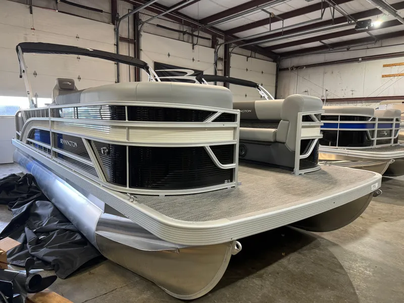 The Image of 2024 Bennington 22SSB pontoon boat in a warehouse setting. - 4