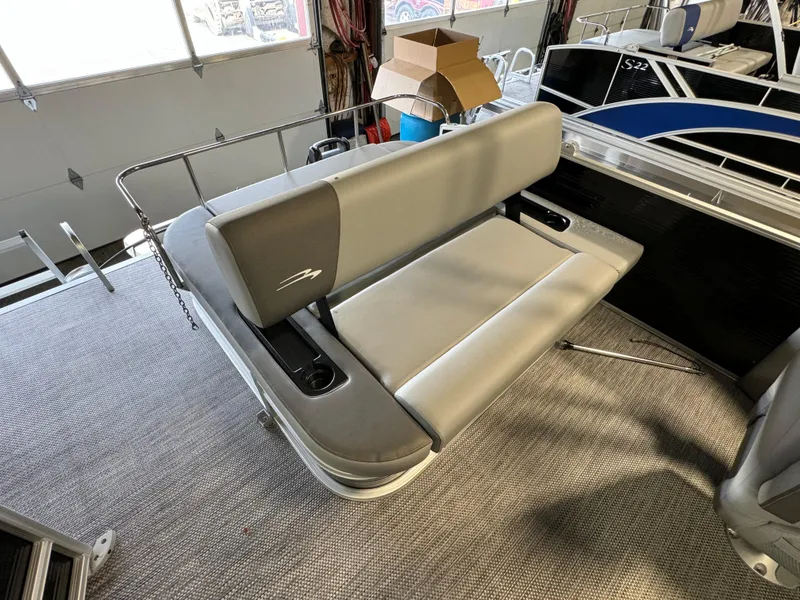 Slide: The Image of 2024 Bennington 22SSB boat interior with gray seating and carpeted flooring. - 8
