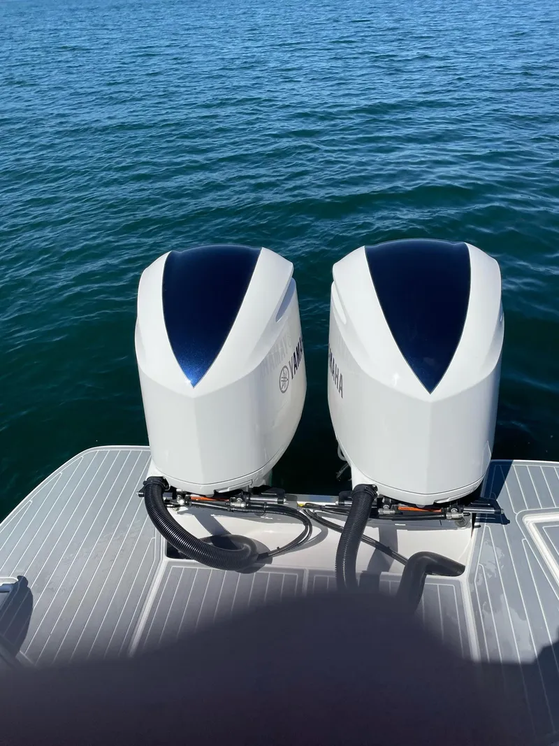 Slide: The Image of 2019 Regal 29 OBX boat with twin outboard motors on the water. - 1