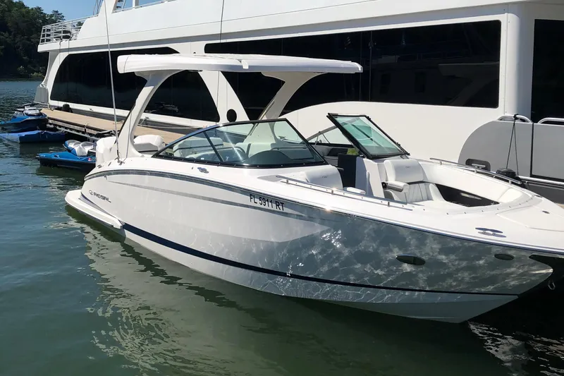 Slide: The Image of 2019 Regal 29 OBX boat docked beside a larger yacht. - 7