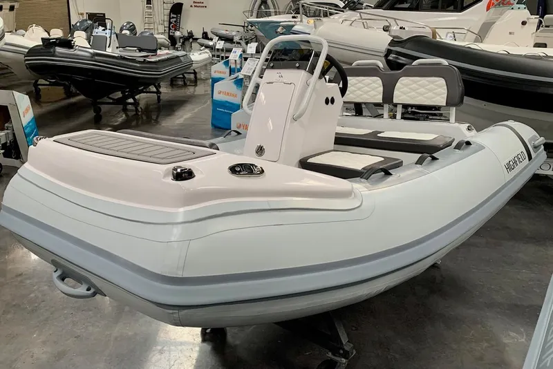 The Image of 2024 Highfield SP300 inflatable boat in showroom, featuring sleek design and modern amenities. - 1