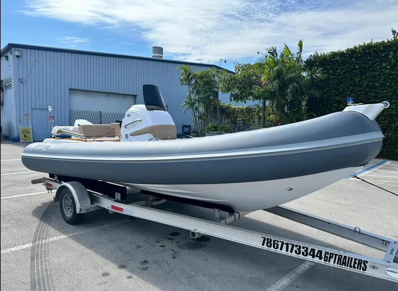 Slide: The Image of 2023 2 Bar 6.20 inflatable boat on trailer in parking lot. - 11