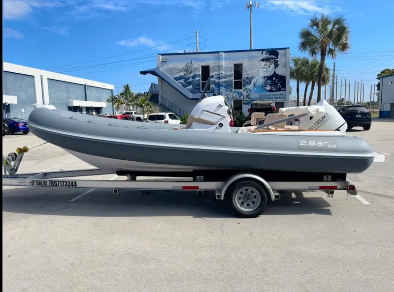 Slide: The Image of 2023 2 Bar 6.20 inflatable boat on a trailer in a parking lot. - 4
