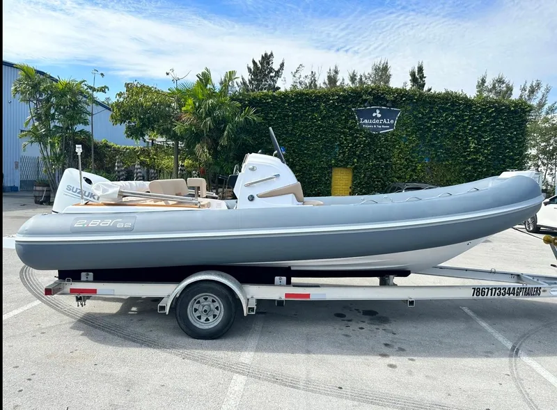 Slide: The Image of 2023 2 Bar 6.20 inflatable boat on trailer with Suzuki outboard motor. - 7