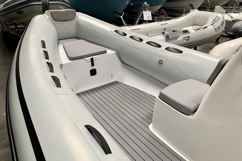 Slide: The Image of 2023 AB Inflatables 15ALX boat interior with seating and storage compartments. - 1