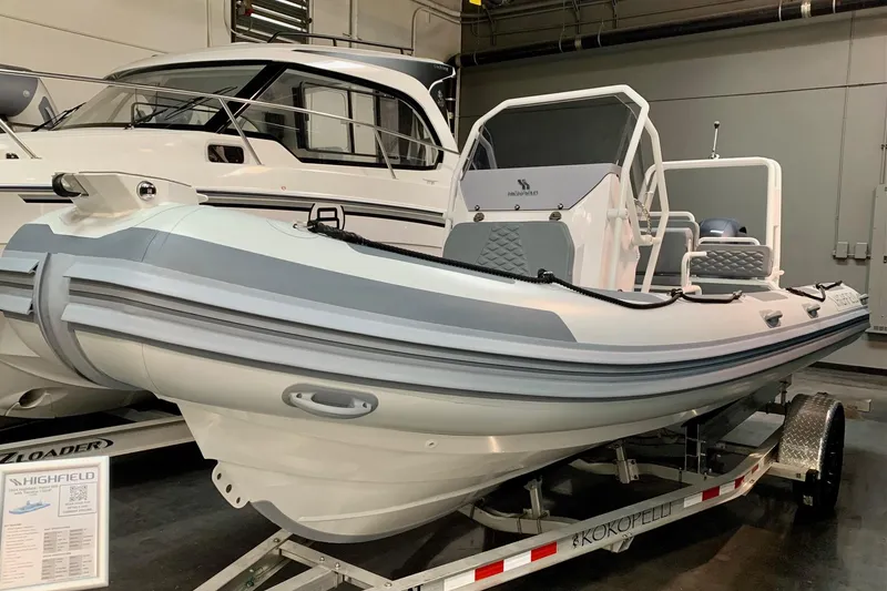 The Image of 2024 Highfield PA600 inflatable boat on trailer in showroom. - 0