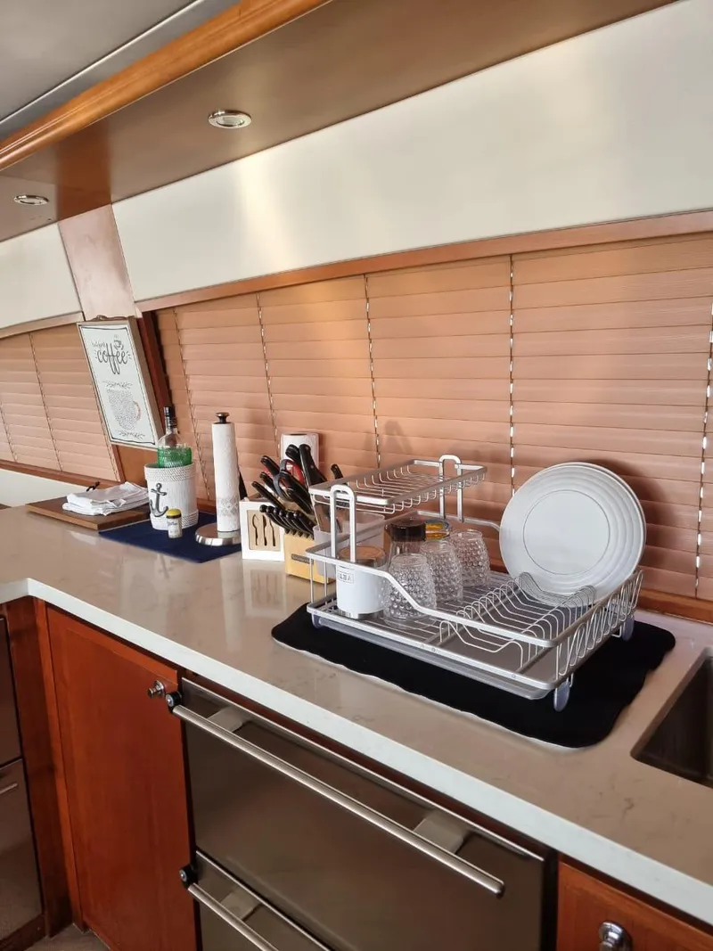 Slide: The Image of Kitchen area of a 2008 Bertram 670 Convertible yacht with dish rack and utensils. - 16