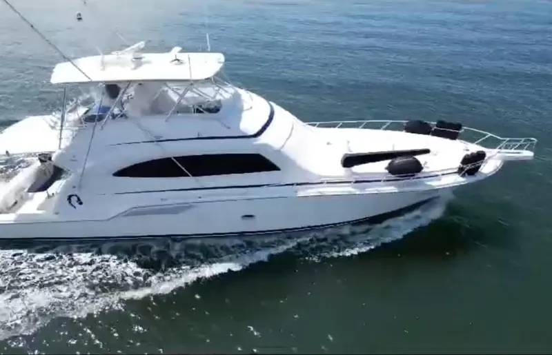 Slide: The Image of 2008 Bertram 670 Convertible yacht cruising on open water. - 2