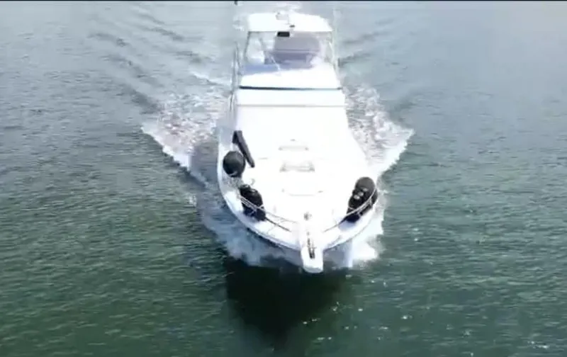 Slide: The Image of 2008 Bertram 670 Convertible yacht cruising on open water. - 3