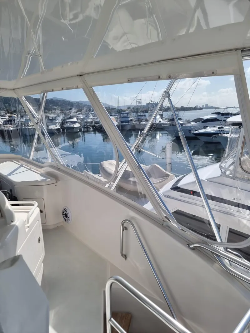 Slide: The Image of 2008 Bertram 670 Convertible yacht interior with marina view. - 4