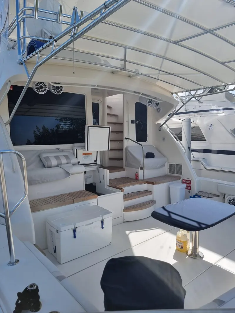 Slide: The Image of 2008 Bertram 670 Convertible yacht with spacious deck and seating area. - 5