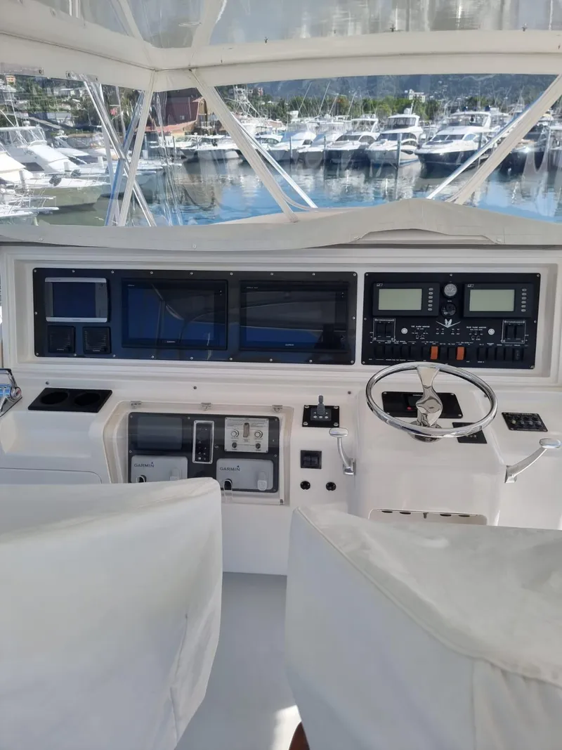 Slide: The Image of 2008 Bertram 670 Convertible yacht cockpit with advanced navigation systems at marina. - 7