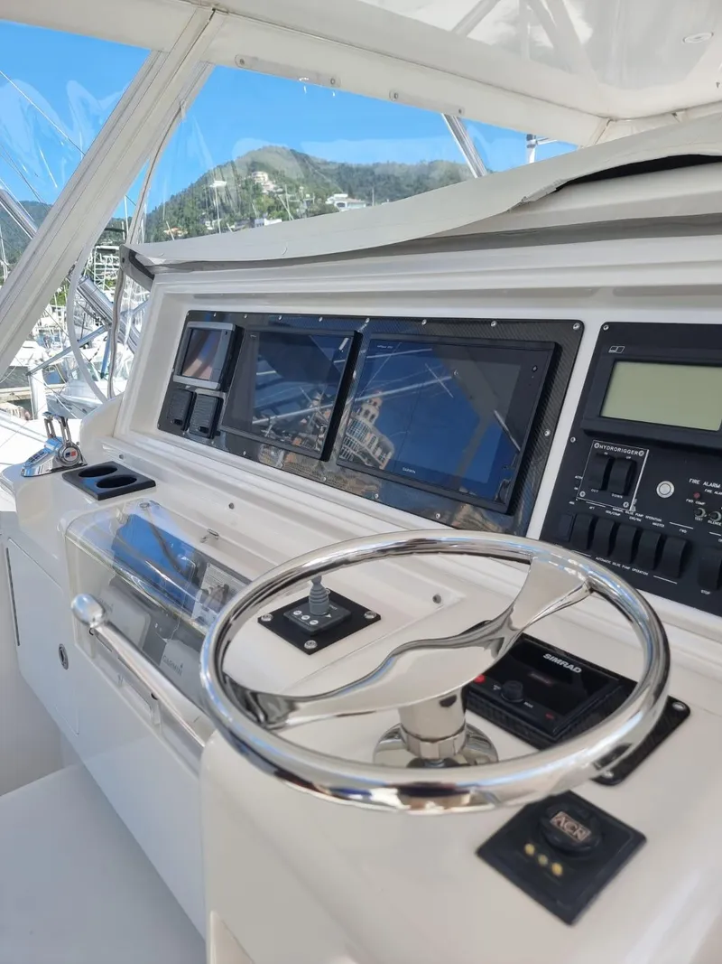 Slide: The Image of Control panel of a 2008 Bertram 670 Convertible yacht with navigation screens. - 8