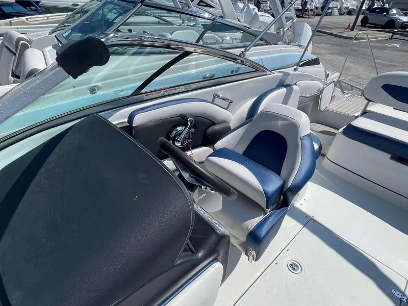 Slide: The Image of 2024 Crownline 250 XSS boat interior with blue and white seating. - 12