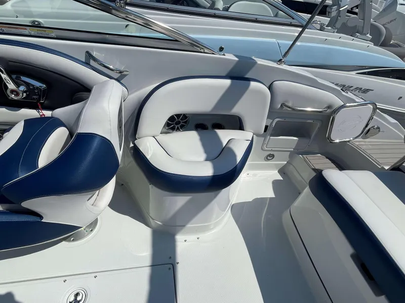 Slide: The Image of 2024 Crownline 250 XSS boat interior with blue and white seating. - 14