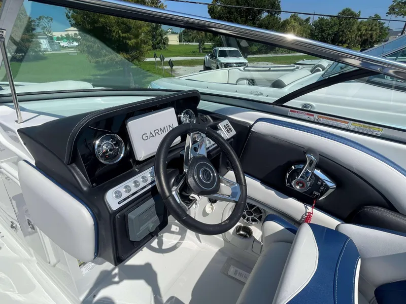 Slide: The Image of 2024 Crownline 250 XSS boat cockpit with Garmin navigation system and sleek steering wheel. - 4