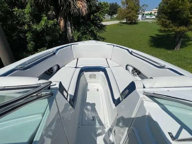 Slide: The Image of 2024 Crownline 250 XSS boat with spacious seating and sleek design. - 5