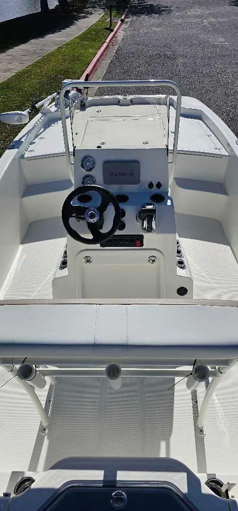 Slide: The Image of 2024 Mako Pro Skiff 19 CC center console boat with steering wheel and controls. - 3