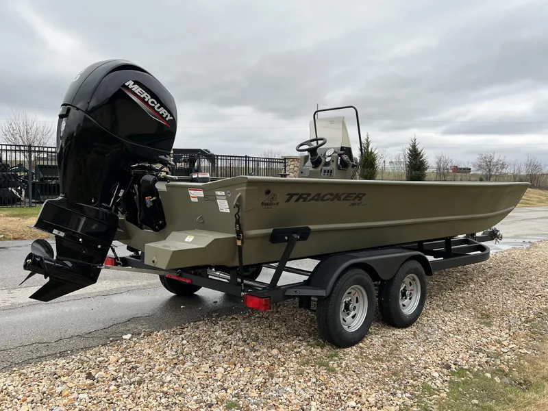 Slide: The Image of 2024 Tracker Grizzly 2072 CC boat on a trailer with a Mercury outboard motor. - 5