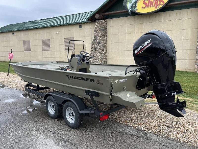Slide: The Image of 2024 Tracker Grizzly 2072 CC boat with Mercury outboard motor on trailer. - 7