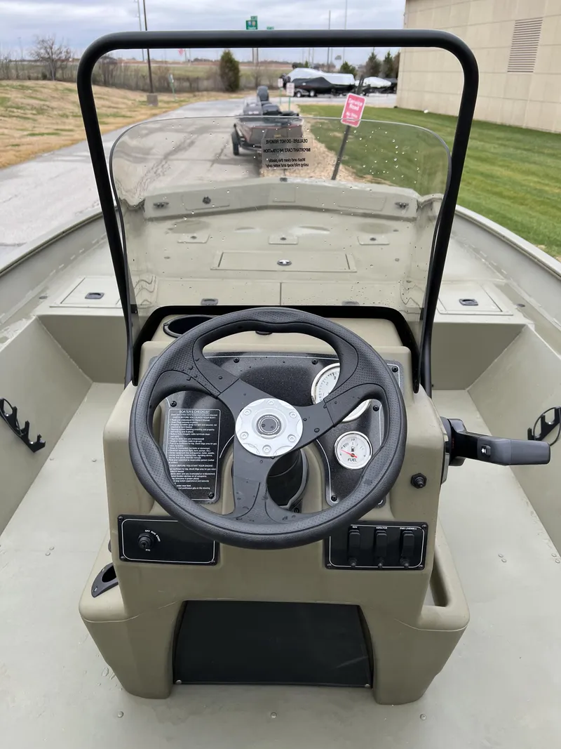 Slide: The Image of 2024 Tracker Grizzly 2072 CC center console boat with steering wheel and controls. - 8