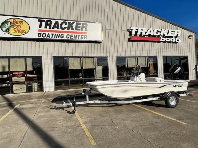 Slide: The Image of 2024 Mako Pro Skiff 15 CC on trailer outside Tracker Boating Center. - 2
