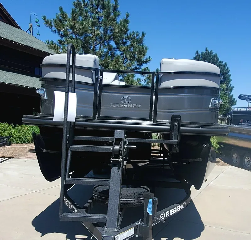 Slide: The Image of 2024 Regency 250 LE3 Sport pontoon boat on trailer. - 2