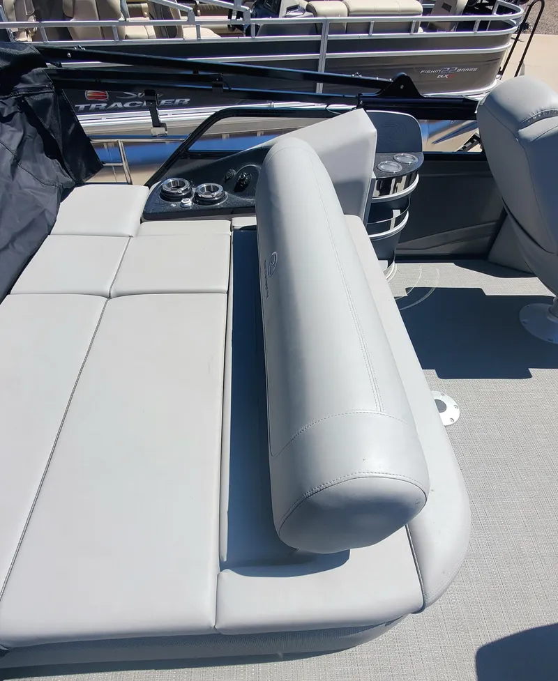 Slide: The Image of 2024 Regency 250 LE3 Sport boat interior with gray seating and control panel. - 6