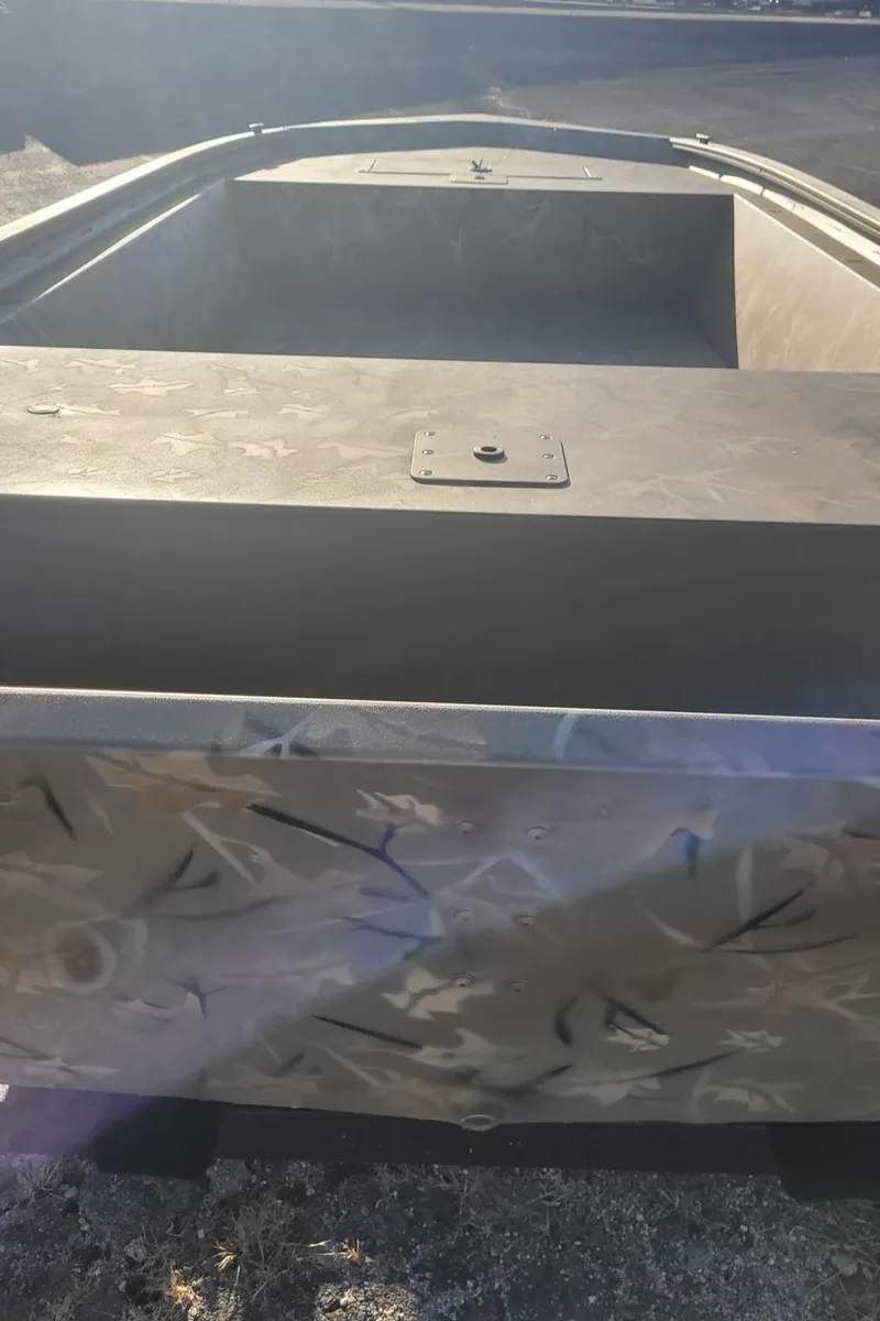 Slide: The Image of 2024 Tracker Grizzly 1648 Jon boat, front view, aluminum finish. - 2