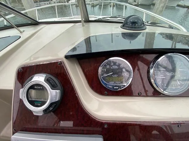 Slide: The Image of Dashboard of a 2011 Sea Ray 280 Sundancer boat with gauges and controls. - 10