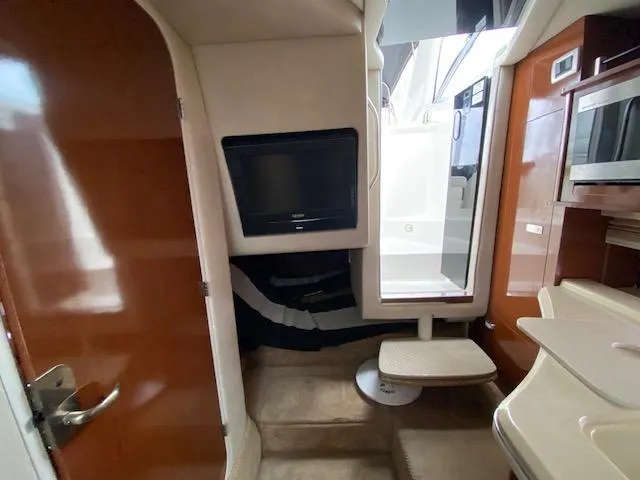 Slide: The Image of Interior of 2011 Sea Ray 280 Sundancer with TV, microwave, and seating area. - 14