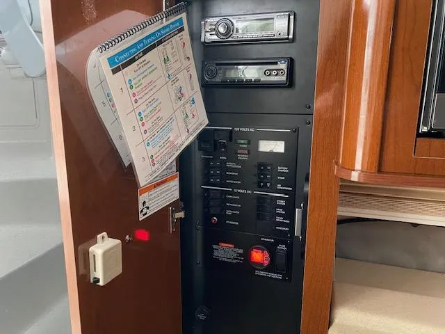 Slide: The Image of Control panel and stereo system inside a 2011 Sea Ray 280 Sundancer boat. - 16