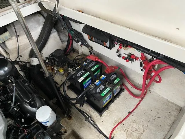Slide: The Image of Engine compartment of a 2011 Sea Ray 280 Sundancer with batteries and wiring. - 19