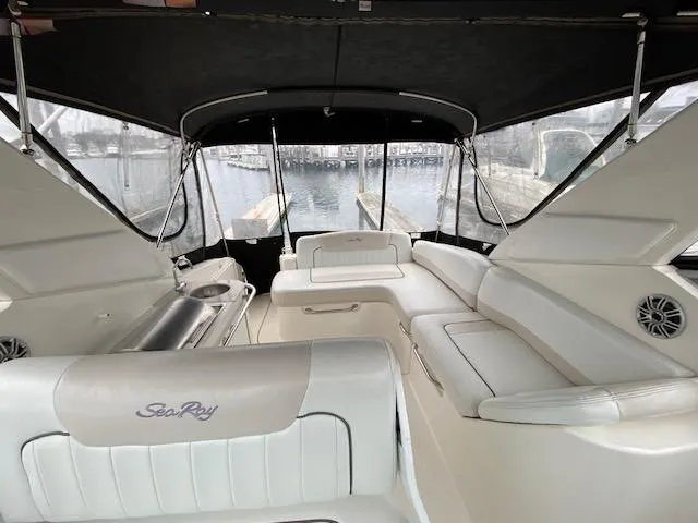 Slide: The Image of 2011 Sea Ray 280 Sundancer boat interior with white seating and waterfront view. - 5