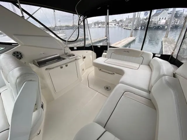 Slide: The Image of Interior of a 2011 Sea Ray 280 Sundancer boat with white seating and waterfront view. - 6