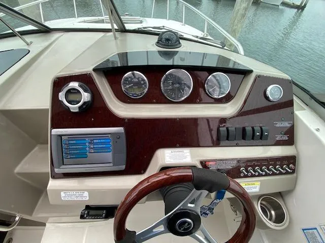 Slide: The Image of Helm of 2011 Sea Ray 280 Sundancer with gauges and controls. - 9