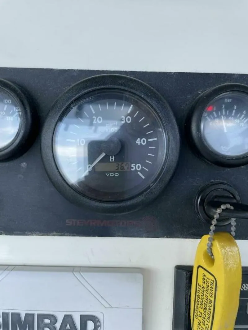 Slide: The Image of Close-up of 1997 Custom 31 Center Console boat dashboard gauges. - 12